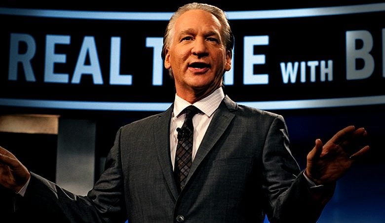 Bill Maher wearing a suit and tie
