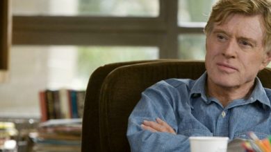 Robert Redford sitting at a table