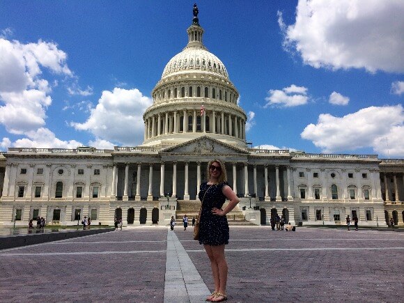 A young woman standing in front of United States Capitol