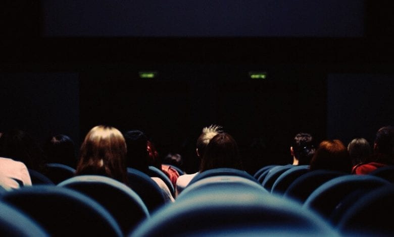 A crowd of people watching a movie