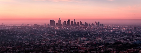 A sunset over a body of water with a city in the background