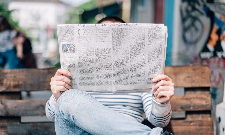 A person reading a newspaper
