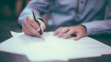 A person writing on a table