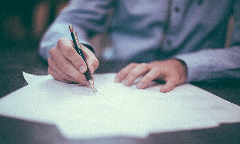 A person writing on a table