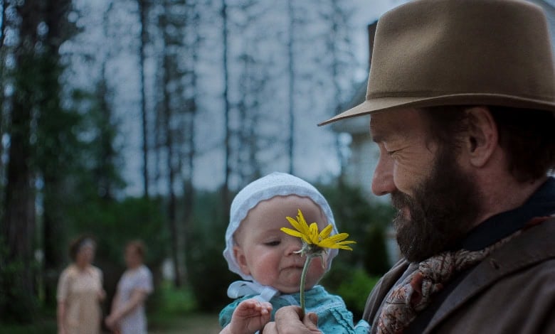 TRAIN_DREAMS_review Joel Edgerton and baby